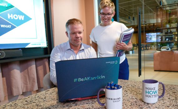 Kate and Brent working together at a laptop