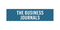 A blue rectangular logo with diagonal lines and the text "The Business Journals" in bold white capital letters at the center.