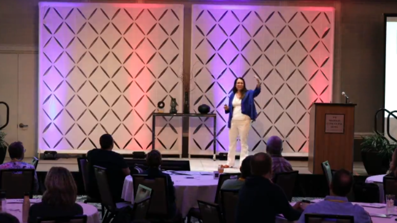 A video thumbnail titled "How to lead with intentional optimism: Inspire your team to explore, take risks, and grow" with colorful wave patterns and a play button in the center. Karrikins Group branding appears on the image.